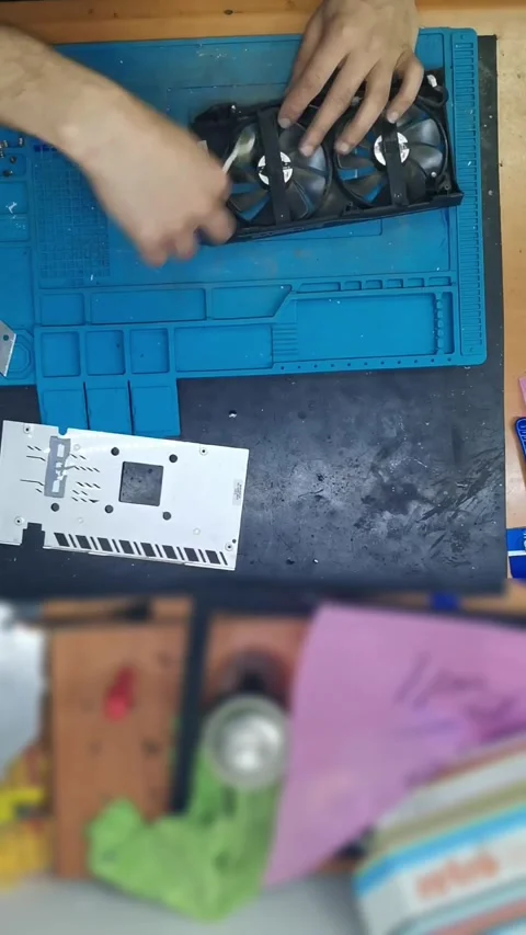 Top-down view of a disassembled high-end graphics card (GPU) on a blue magnetic 動画素材 333525405