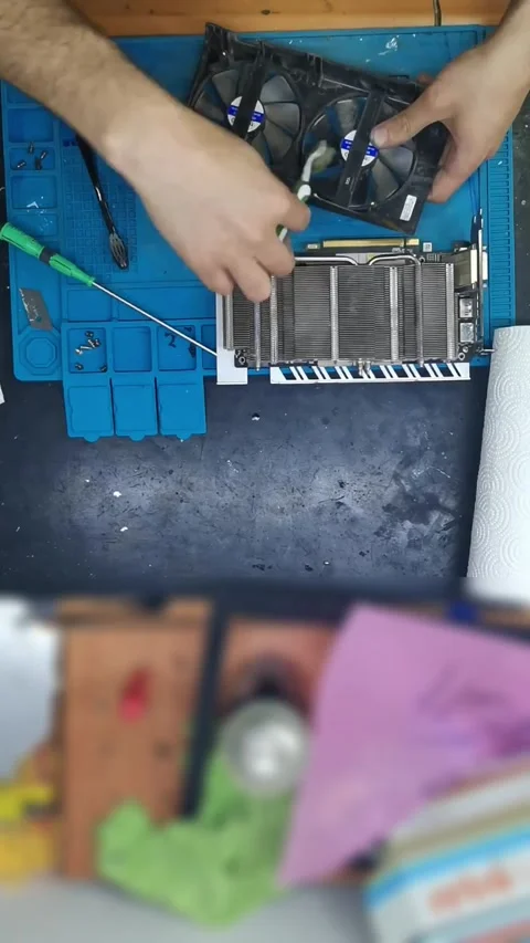 Top-down view of a disassembled high-end graphics card (GPU) on a blue magnetic 動画素材 333525573