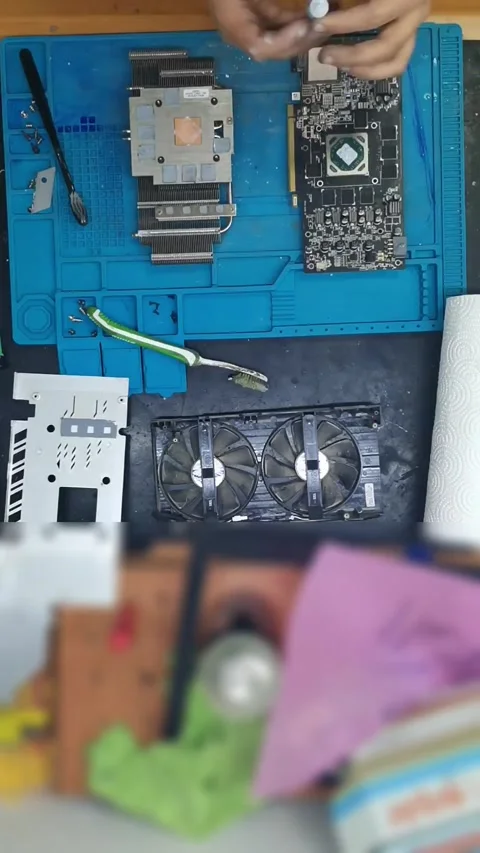 Top-down view of a disassembled high-end graphics card (GPU) on a blue magnetic Stock-Footage 333525784