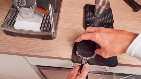 Top Down View Distributing Ground Coffee in Portafilter with Tool on Rubber Mat Vídeo Stock 328855975