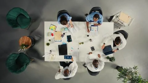 Top down view of diverse physicians team reviewing clinical records Stock Photos
