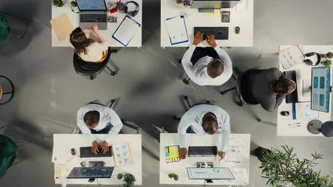 Top down view of diverse staff in office working on forecasting Stock Photos