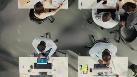 Top down view of diverse staff in office working on forecasting Stock Photos