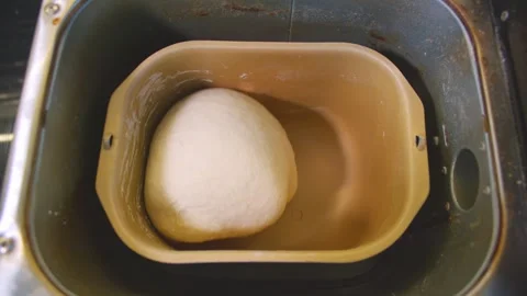 Top down view of dough being kneaded in a bread maker Stock Footage 249807191