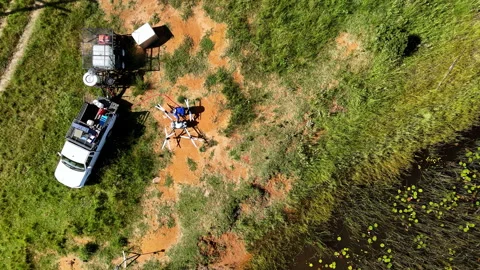 Top-Down View of Drone Being Refilled with Herbicide by Pond 스톡 동영상 334019346
