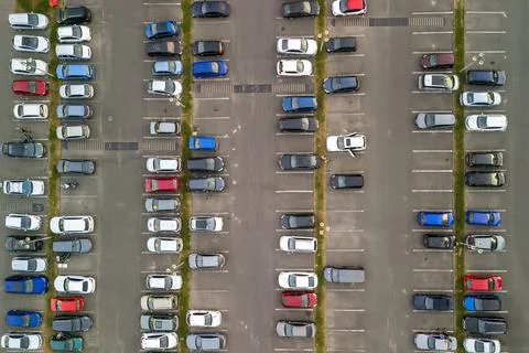 Top down view from drone on mall parking with many cars. Aerial drone view of a Stock Photos