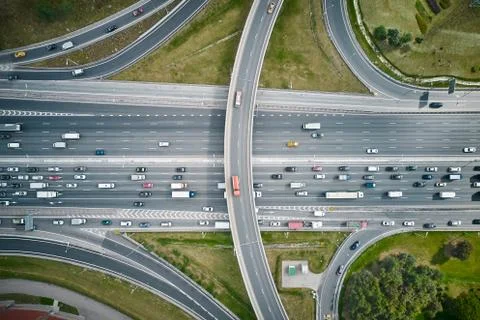 Top down view from drone on overpass with road traffic. Cloudy weather. Stock Photos
