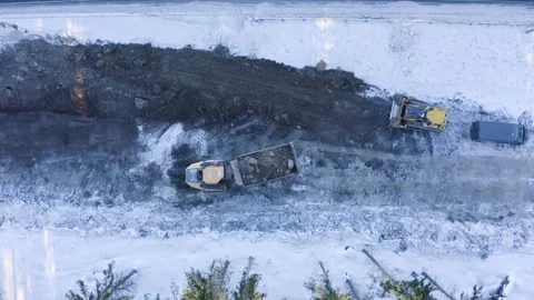 Top-down view of a dump truck dumping crushed stone in front of a bulldozer Stock Footage 148484596
