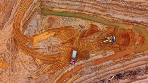 Top down view of dump truck and excavator at mining site. Overhead drone capture Stock Footage 336483691