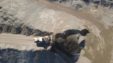Top Down View of Dump Truck Unloading Crushed Aggregate at Quarry Video stock 347947135