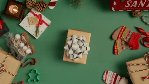 Top down view of elegant craft paper gift box with silver bow on green backdrop Stock Footage 255316614