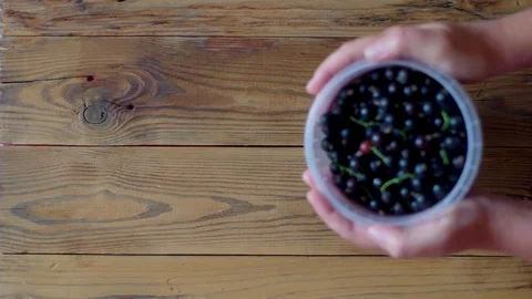 Top-Down View of Emptying the Plastic Container of Berries Stock Footage 112486355