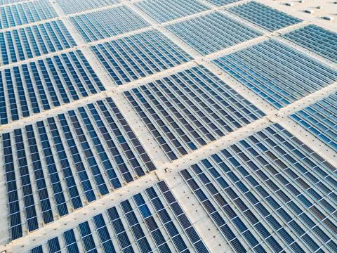 Top down view of endless fields of solar panels providing green energy Stock Photos