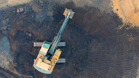 Top Down View of Excavator Creating Circular Digging Pattern in Mining Site Vídeos de archivo 294004105