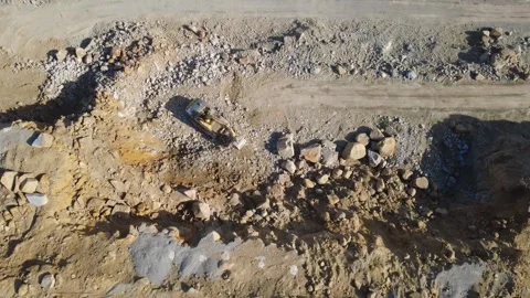 Top Down View of Excavator Digging and Dumping Rocks in Granite Quarry Stock-Footage 347945013