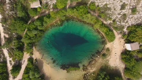 Top Down View of Eye of the Earth Basin with Sandy Shoreline Paths Stock Footage 346189066