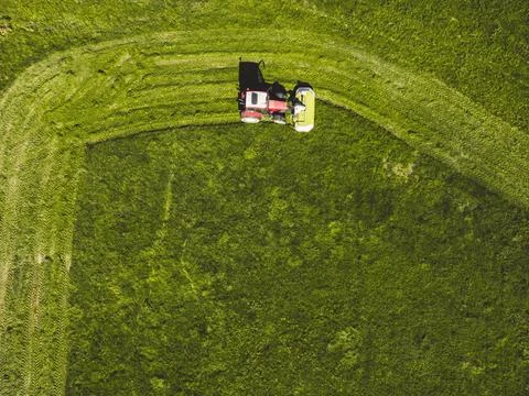Top down view farmer mowing a green grass field Stock Photos