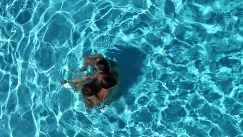 Top down view of father and two and Children Enjoying a Summer Day Swimming Stock Footage 280862892
