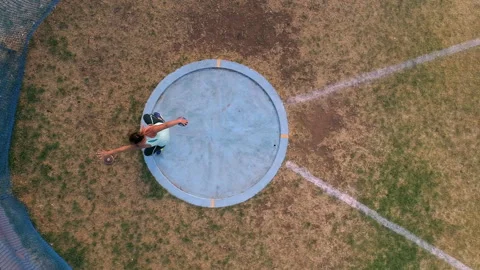 Top down view as female athlete throws discus at track and field event Stock Footage 305735597