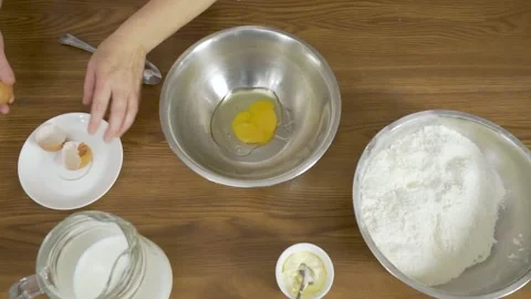 Top down view of female hands break white chicken egg and split yolk and egg Stock Footage 140060310