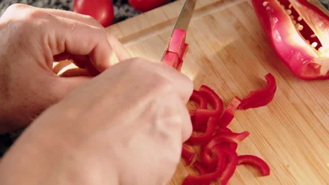 Top down view female hands cut red fresh pepper on board close-up. Preparing Stock Footage 221423246
