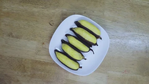 Top down view of five steamed yellow bananas with dark peels on a white squ.. Stock Footage 335939749