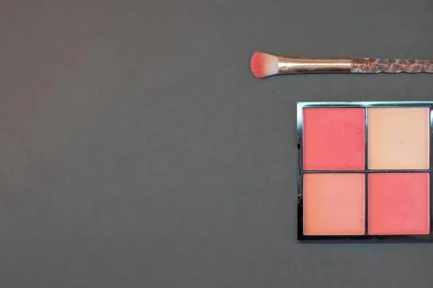 Top down view flat lay of a make up box a with a brush on a black background. Stock Photos