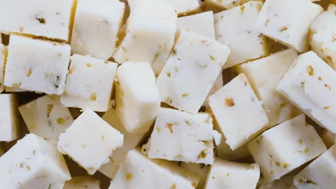 Top down view of flavorful herbed cheese blocks in close detail. Slider shot Video stock 296565482