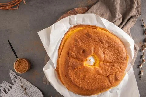 Top down view of a fluffy golden Pao de Lo sponge cake on white parchment p.. Stock Photos