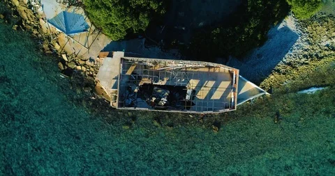 A top-down view fly over a shipwreck on a reef with beautiful turquoise water Stock-Footage 97966438