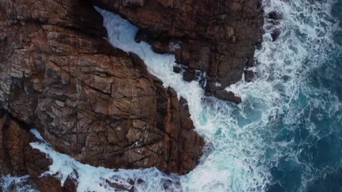 Top Down View Of Foamy Waves Splashing On Rugged Cliffs In Arteixo Stock Footage 236546177