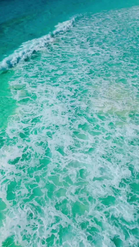 Top down view of foamy waves over turquoise Caribbean water Stock Footage 342090323