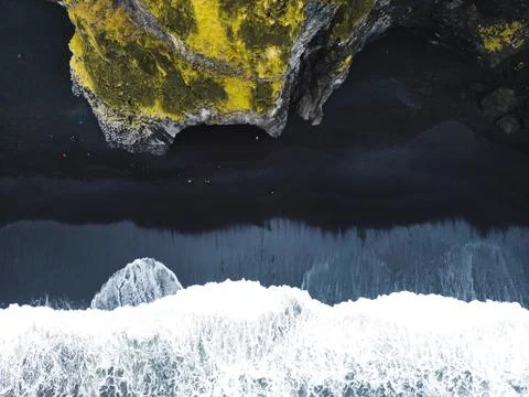 Top down view of foamy waves landing on the black beach of Reynisfjara Stock Photos