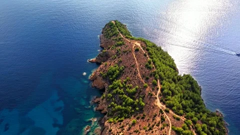 Top down view of a forested peninsula tip in deep blue sea, Thassos Stock Footage 347172228