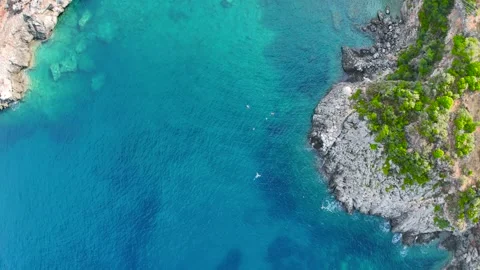 Top Down View of Freedivers in Turquoise Mediterranean Cove Stock Footage 336839364