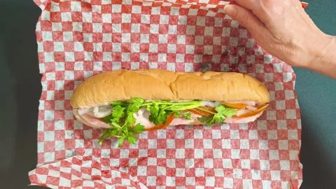 Top down view of fresh crispy Subway sandwich with ham, tomato, cucumber, l.. Video stock 318253976