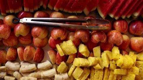Top down view of fresh fruit platter with apples, pineapple, bananas, watermelon Stock Footage 314651208