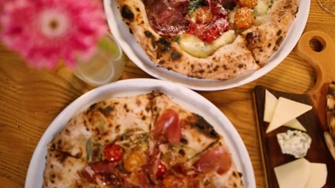 Top Down View of Fresh Neapolitan Pizzas on Wooden Restaurant Table Stock Footage 337995341