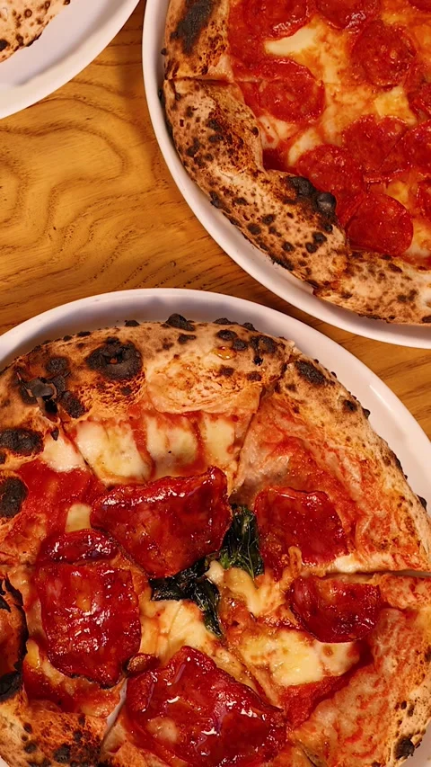 Top Down View of Fresh Neapolitan Pizzas on Wooden Table Stock Footage 340135506
