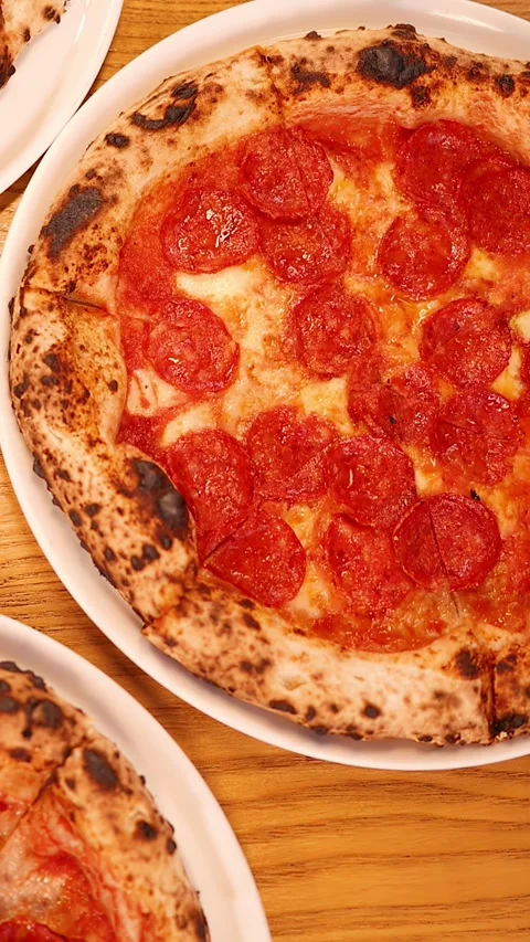 Top Down View of Fresh Pepperoni Pizza on Wooden Table Stock Footage 337876872