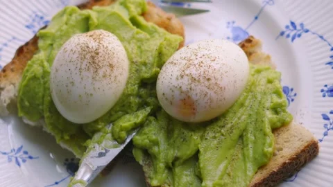 Top Down View of Fresh Soft Boiled Eggs with Smashed Avocado on Sourdough Bread. Stock Footage 341605840