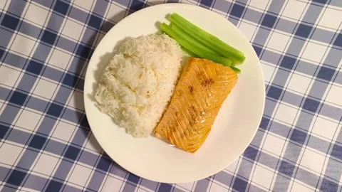 Top down view of freshly cooked delicious salmon with rice and crisp celery  Stockbeeldmateriaal 318254642