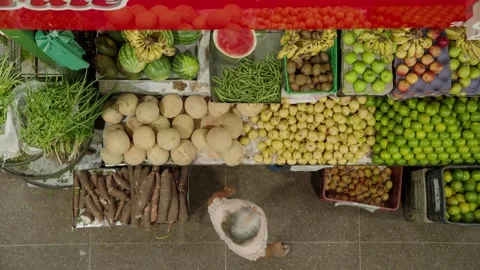 Top down view of fruit and vegetable stand with customers at a local market Stock Footage 337705756