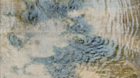 Top down view of gentle water ripples on a shallow sandy stream Video stock 336400588