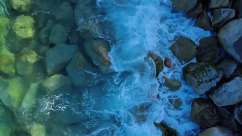 Top Down View of Gentle Waves Breaking on Coastal Rocks Stock Footage 332483126