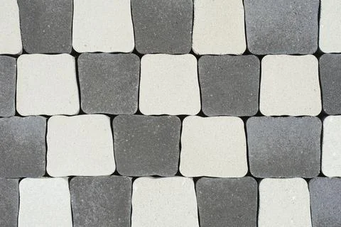 Top-down view geometric pattern featuring interlocking grey and white concr.. Stock Photos