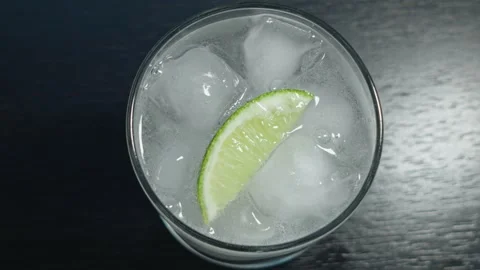 Top down view of a gin and tonic with a lime Stock Footage 315417818