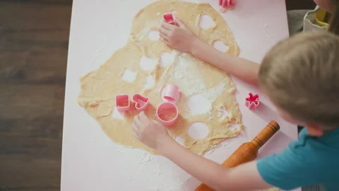 Top Down View of Girl Adding Flour into Shape Cutter While Baking Stock Footage 307970409