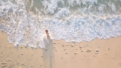 Top down view girl in bikini walk on the sans beach upcoming ocean waves Stock Footage 100653567