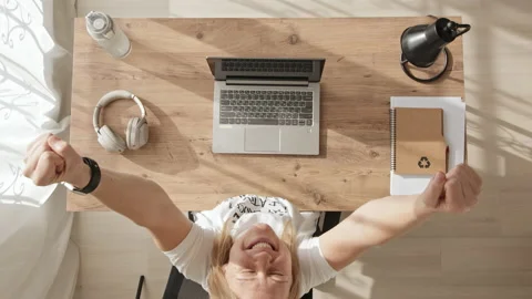 Top down view of girl working at computer, achieving success and joy. young Stock Footage 231950811
